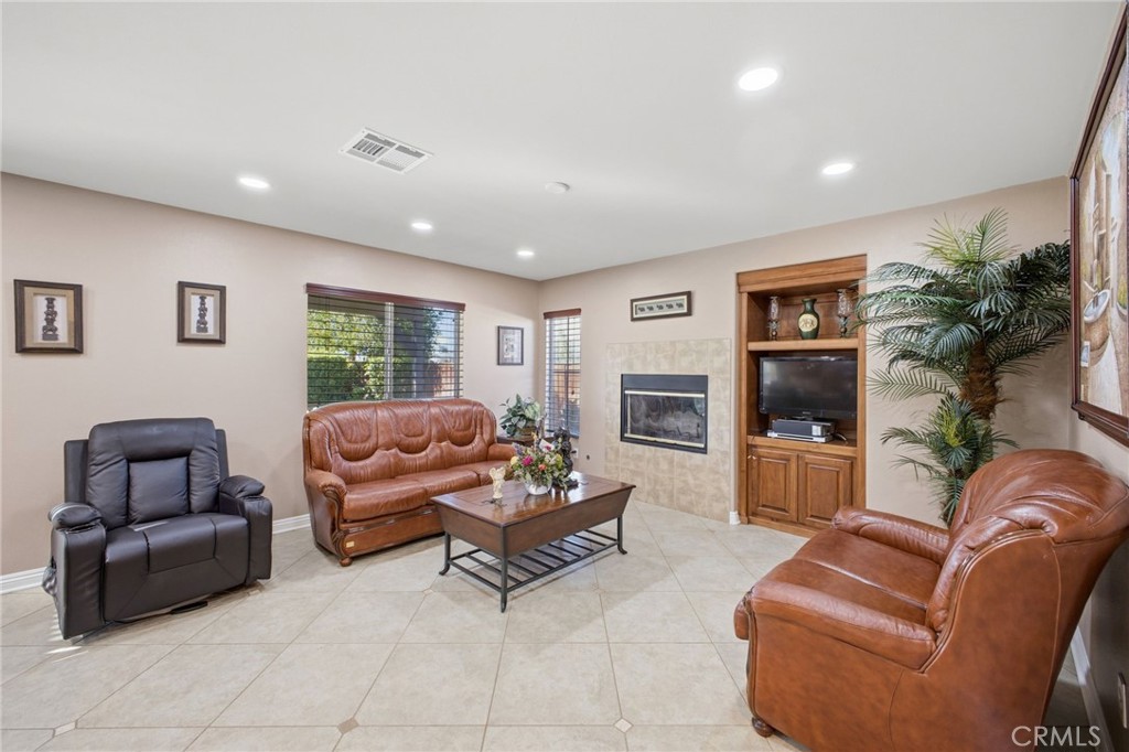 785 Pine Ridge Circle Beaumont, CA 92223 - Photo 16 of 60 Family room with cozy fireplace - beautiful tile continues