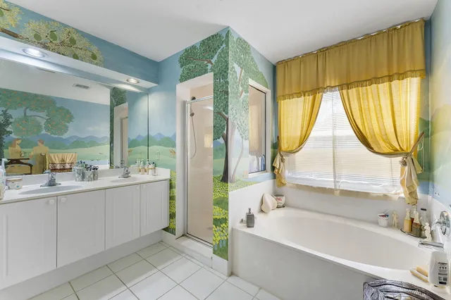 a bathroom with a tub sink and mirror