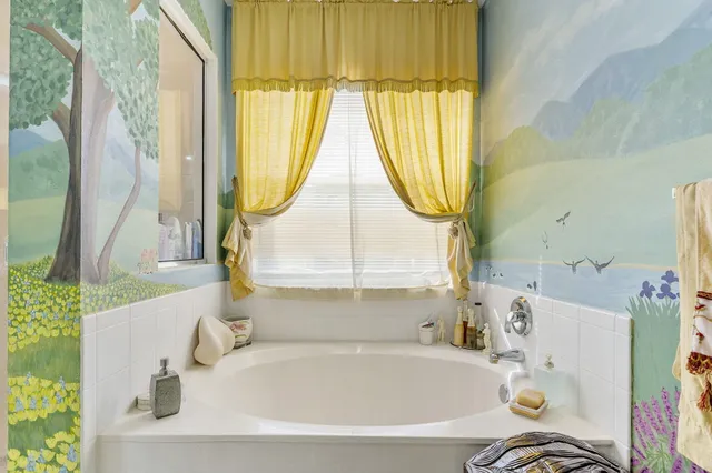 a bath tub sitting next to a window
