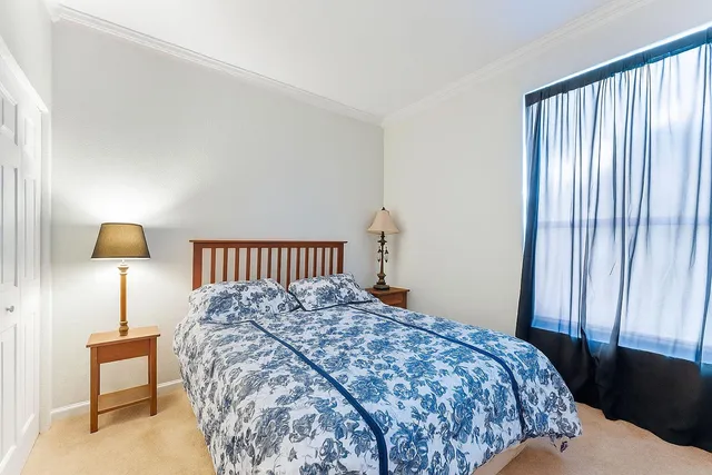 a bedroom with a bed and a lamp on table