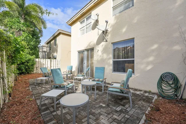 a couple of chairs sitting in backyard of a house