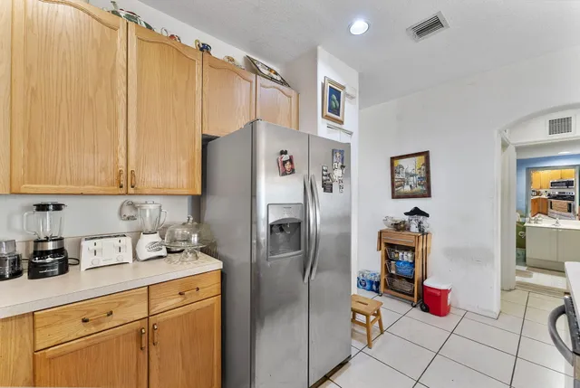 a kitchen with stainless steel appliances granite countertop a refrigerator and a sink