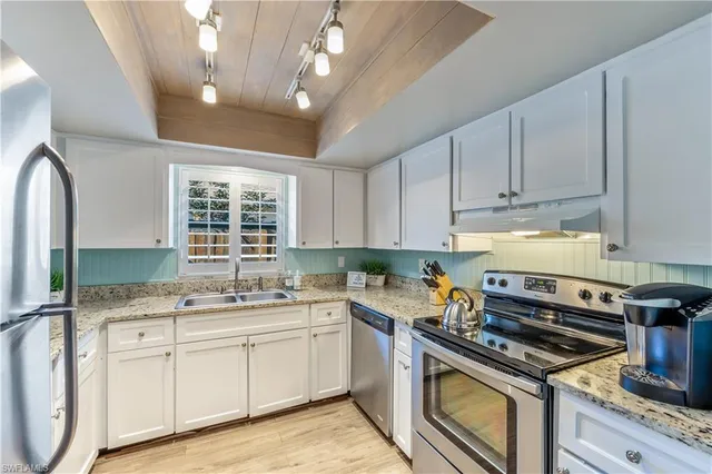 a kitchen with a stove a sink and a microwave