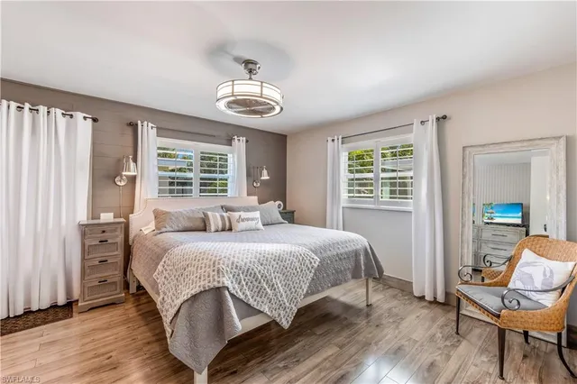 a bedroom with a large bed and a window