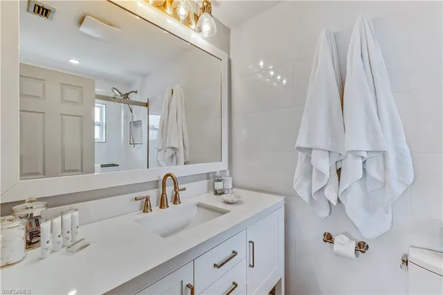 a bathroom with a sink vanity and a mirror