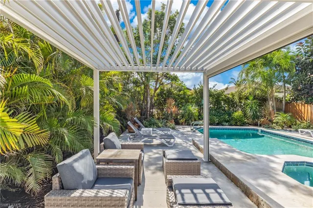 a view of backyard with swimming pool and outdoor seating