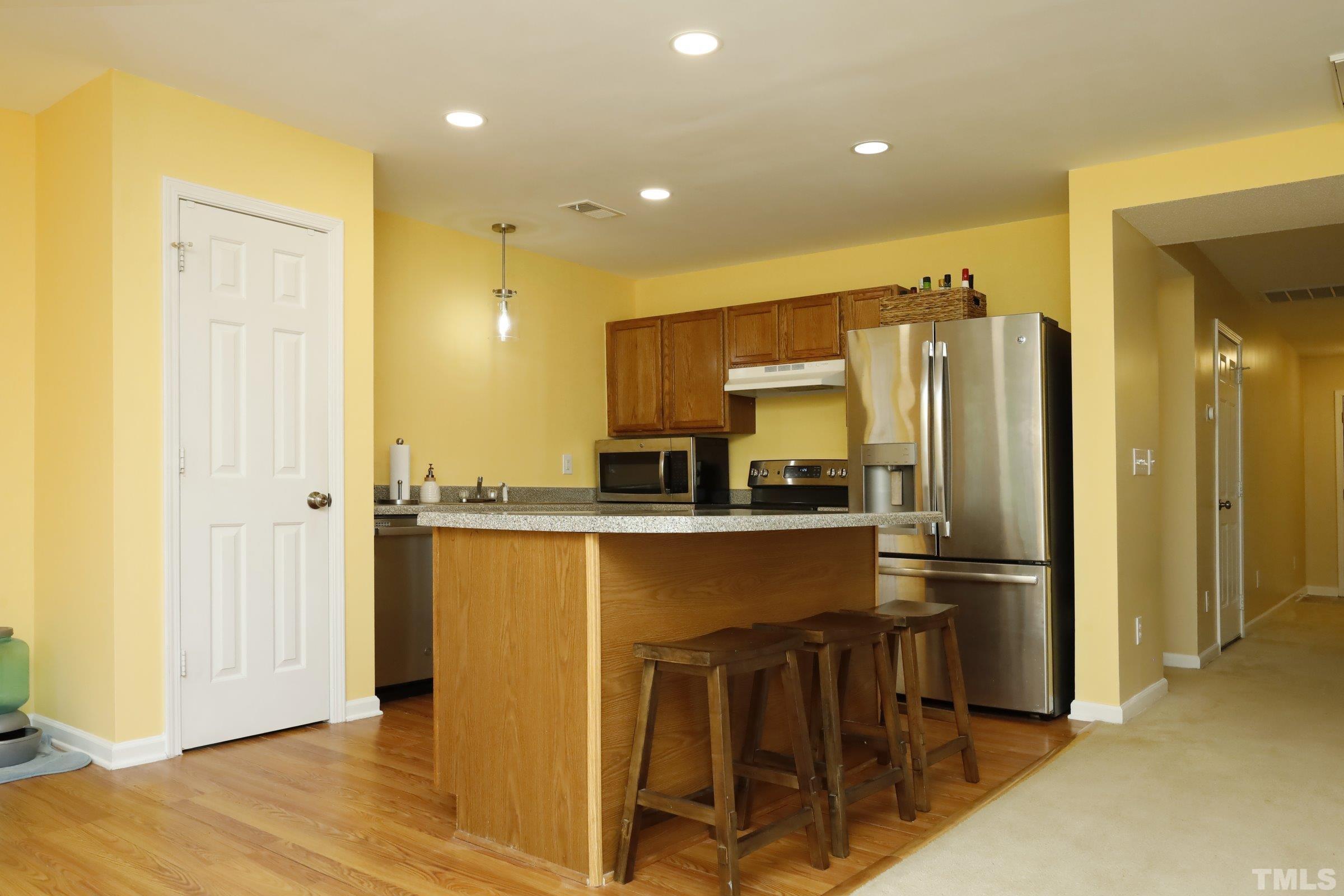 3608 Marshlane Way Raleigh, NC 27610 - Photo 13 of 43 a kitchen with stainless steel appliances granite countertop a refrigerator and a stove top oven