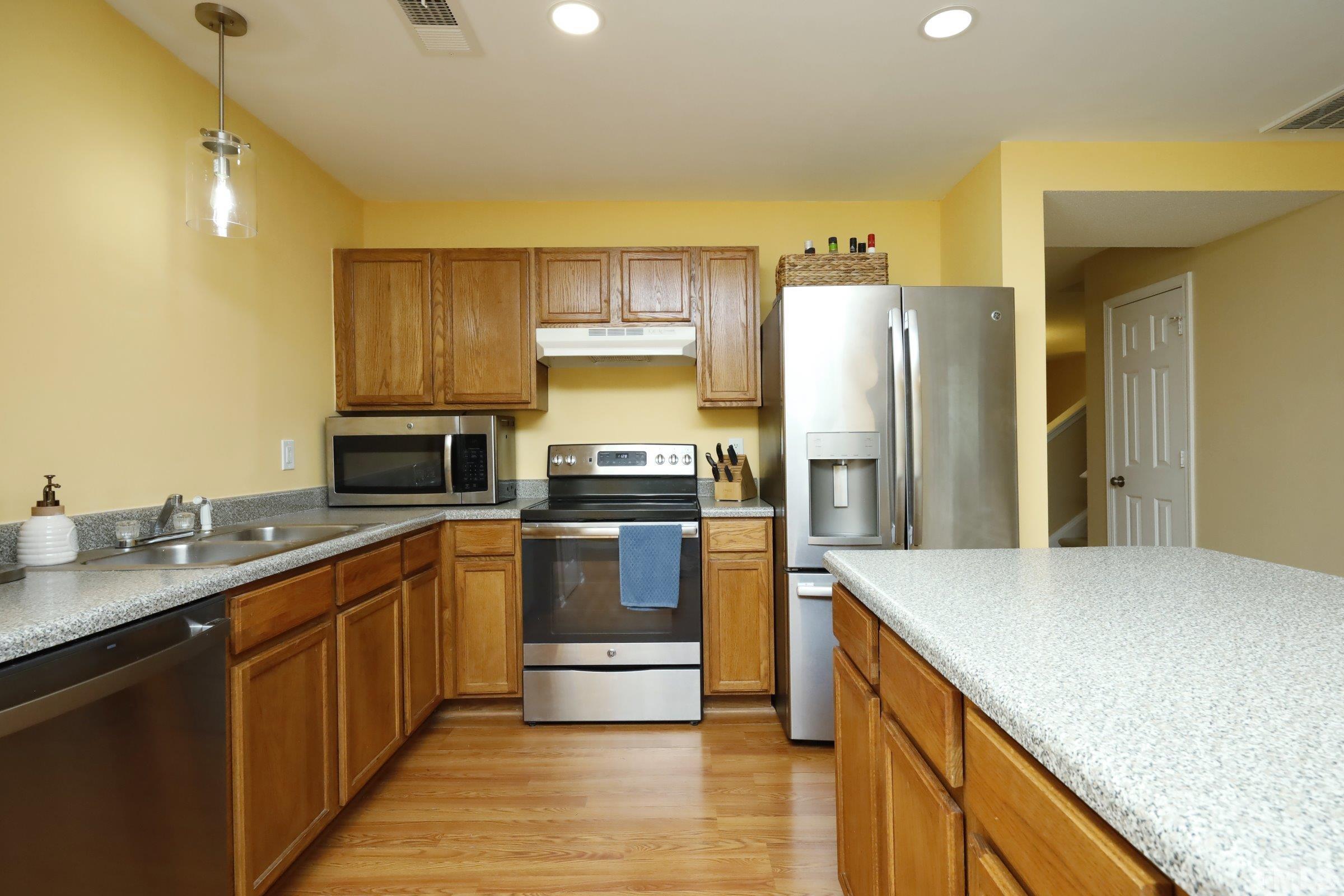3608 Marshlane Way Raleigh, NC 27610 - Photo 14 of 43 a kitchen with stainless steel appliances granite countertop a refrigerator a stove and a sink