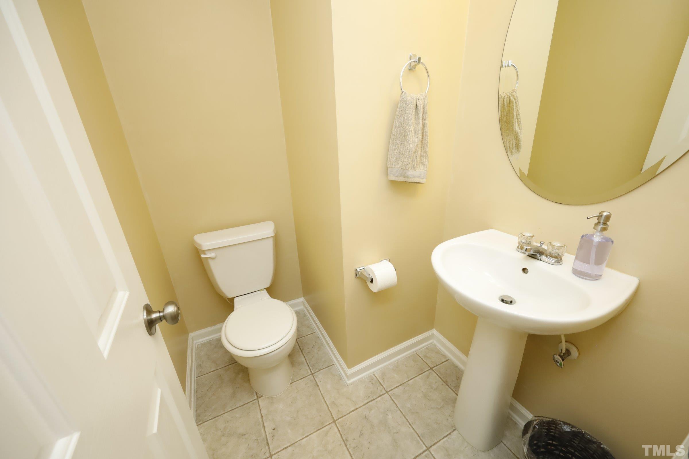3608 Marshlane Way Raleigh, NC 27610 - Photo 19 of 43 a bathroom with a toilet sink and mirror