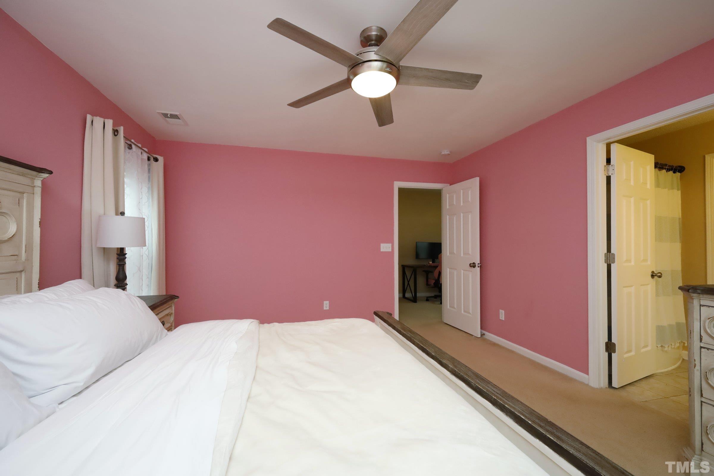 3608 Marshlane Way Raleigh, NC 27610 - Photo 24 of 43 a bedroom with a bed chandelier and a window