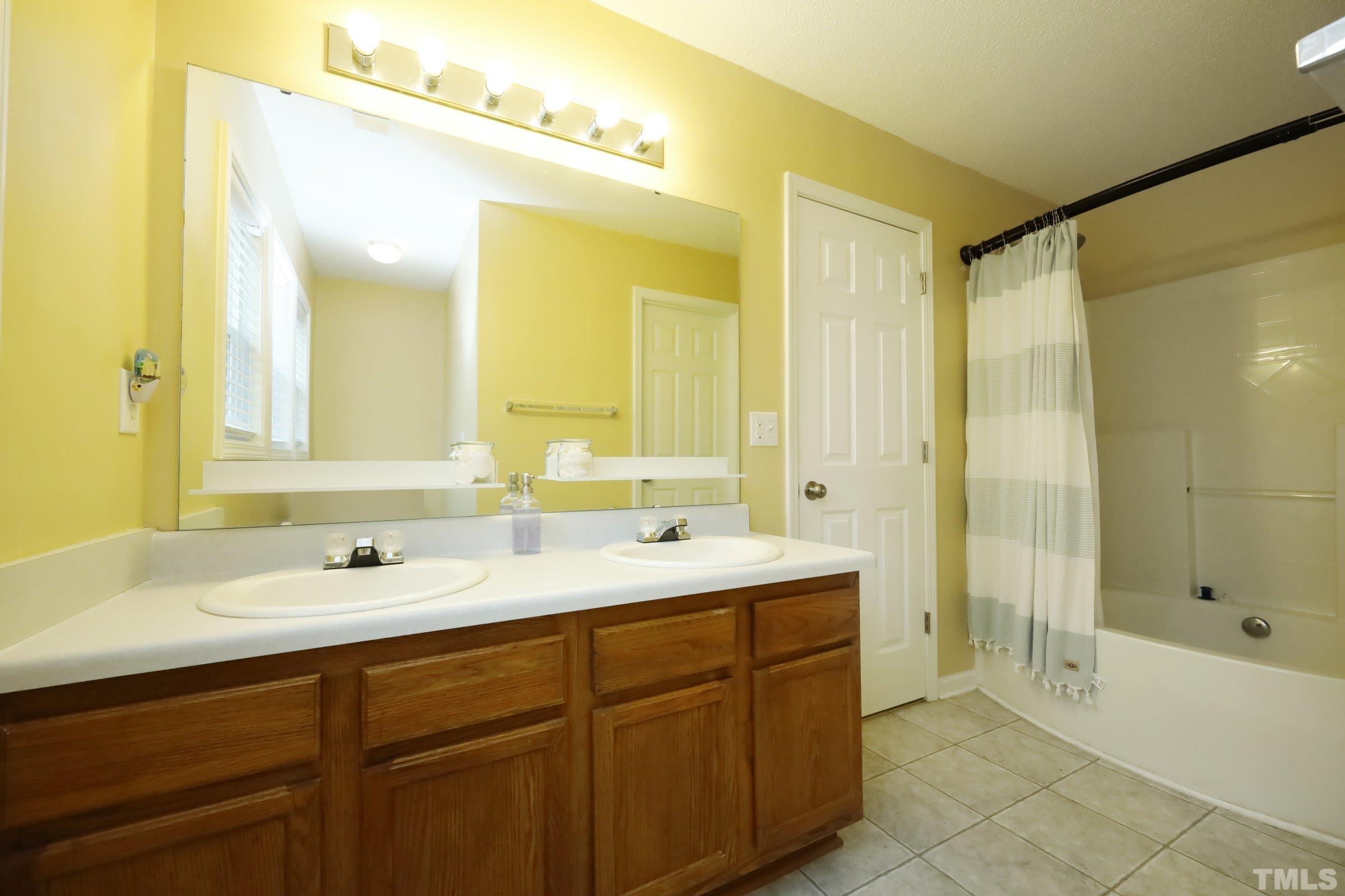 3608 Marshlane Way Raleigh, NC 27610 - Photo 25 of 43 a bathroom with a sink double vanity and a mirror
