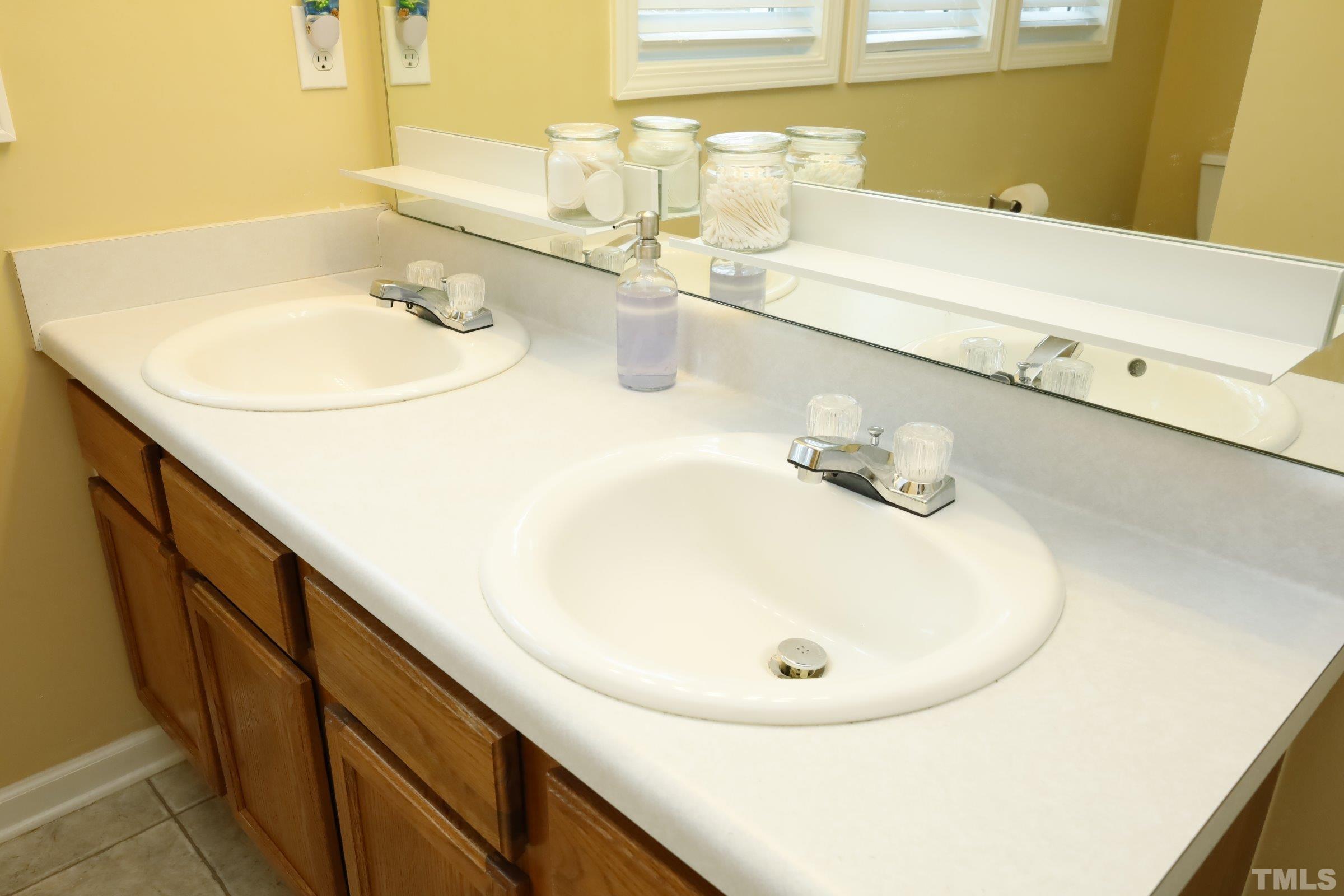 3608 Marshlane Way Raleigh, NC 27610 - Photo 27 of 43 a bathroom with a sink and a mirror