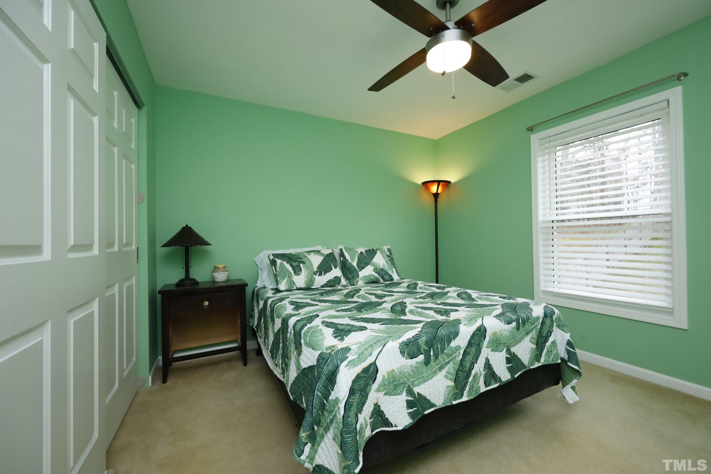 3608 Marshlane Way Raleigh, NC 27610 - Photo 28 of 43 a bedroom with a bed and a chandelier