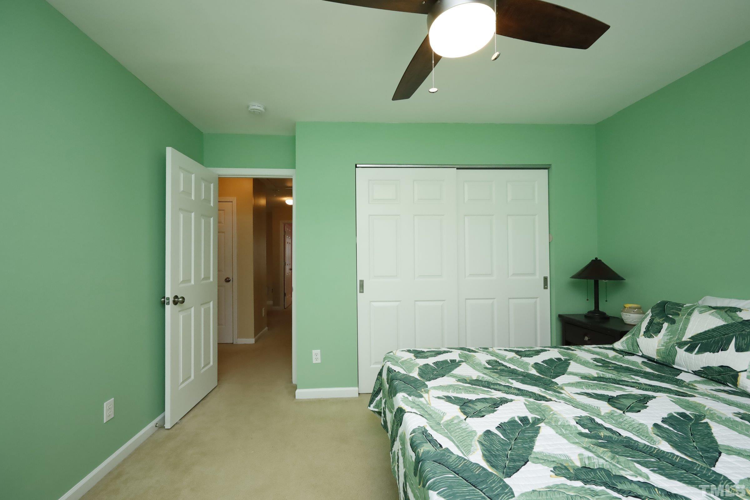 3608 Marshlane Way Raleigh, NC 27610 - Photo 29 of 43 a bedroom with a bed and a chandelier