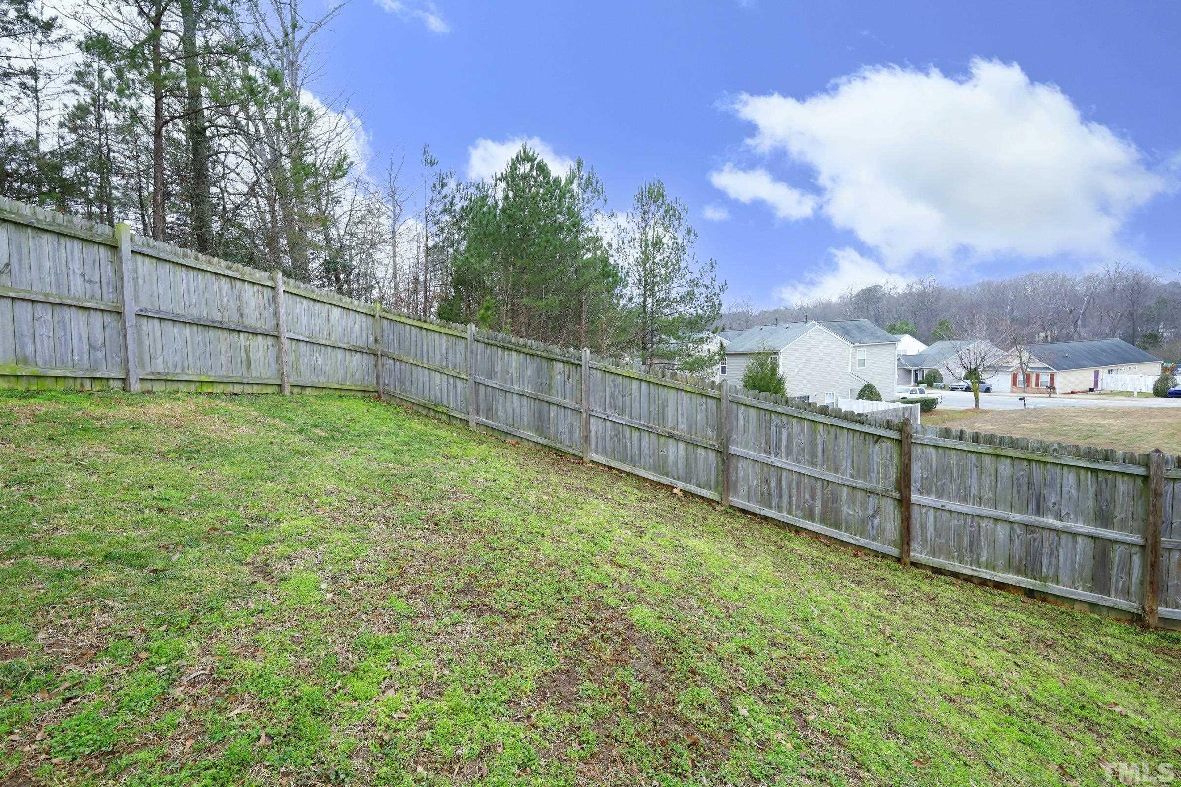 3608 Marshlane Way Raleigh, NC 27610 - Photo 39 of 43 a view of a yard with a fence