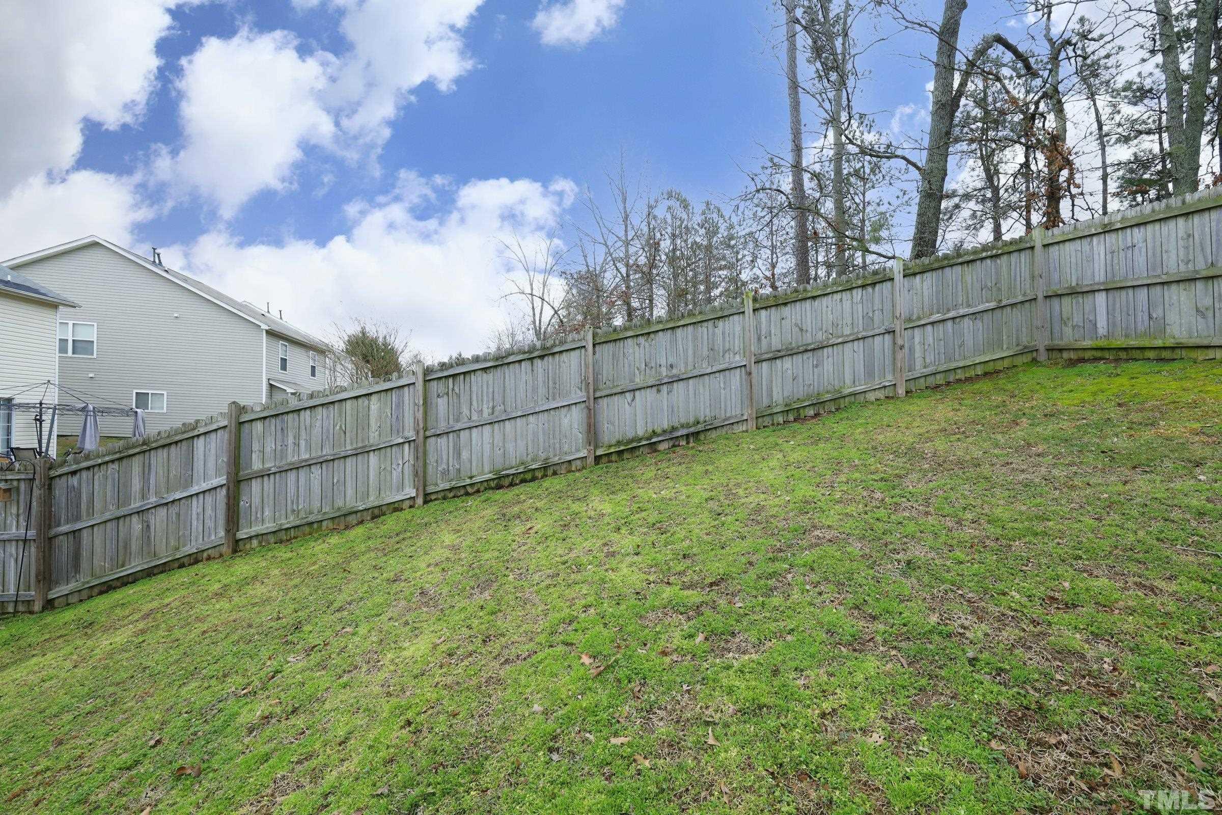 3608 Marshlane Way Raleigh, NC 27610 - Photo 40 of 43 a view of a backyard with wooden fence