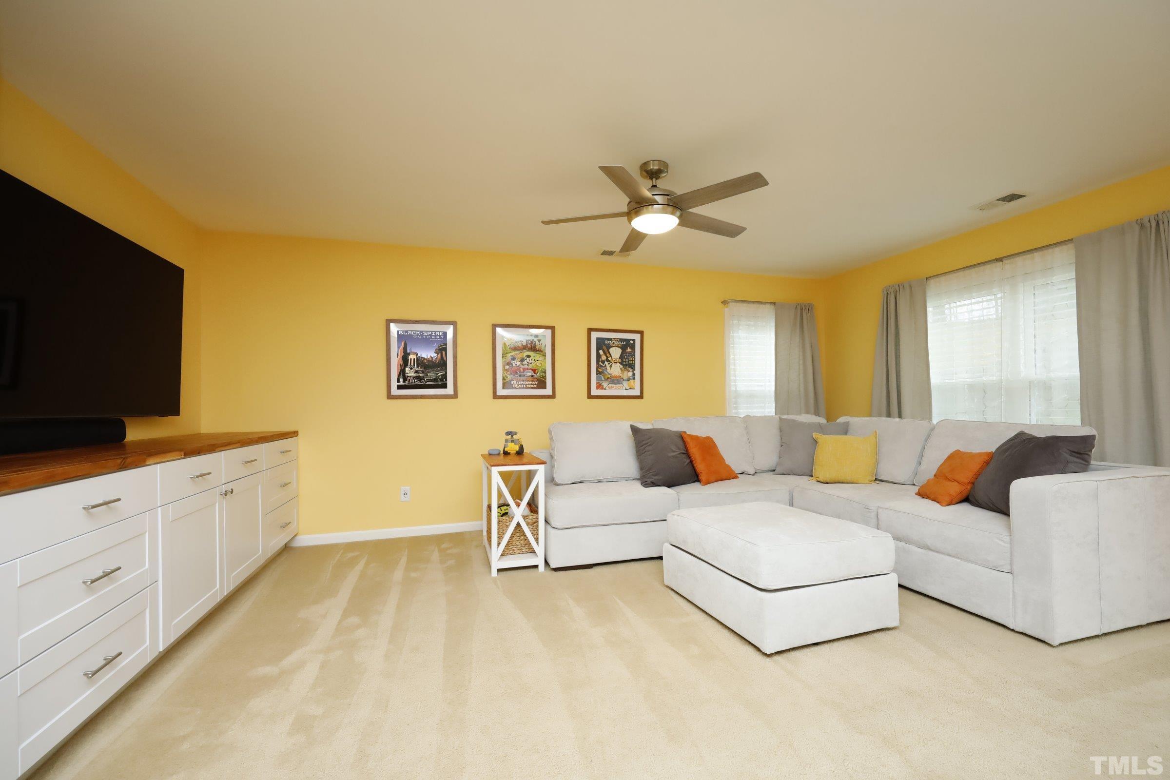 3608 Marshlane Way Raleigh, NC 27610 - Photo 6 of 43 a living room with furniture and a flat screen tv