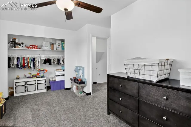 a spacious bedroom with a bed and a chandelier