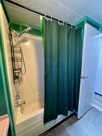 a bathroom with a shower and a tub