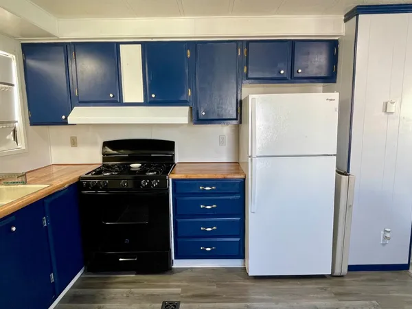 a kitchen with a refrigerator and a stove