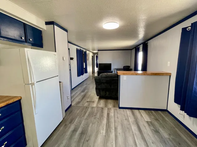 a kitchen with stainless steel appliances a refrigerator and a microwave