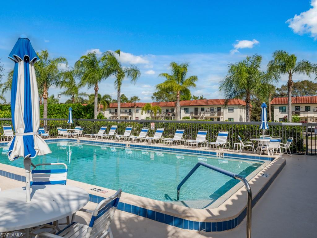 a view of a swimming pool and lounge chairs