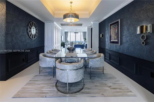 a living room with couches chairs and kitchen view
