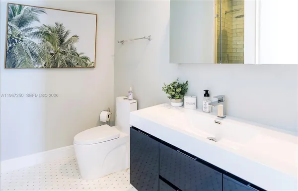 a bathroom with a sink a toilet and a mirror