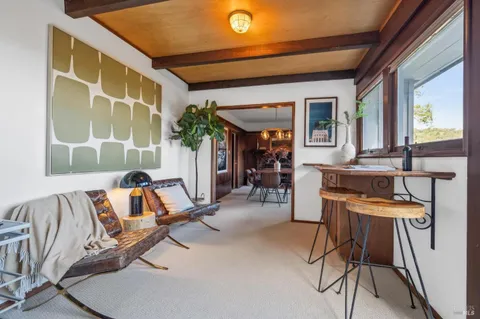 a view of a room with table and chairs