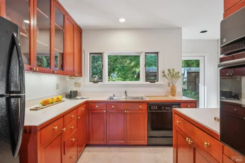 a kitchen with a sink stove and cabinets