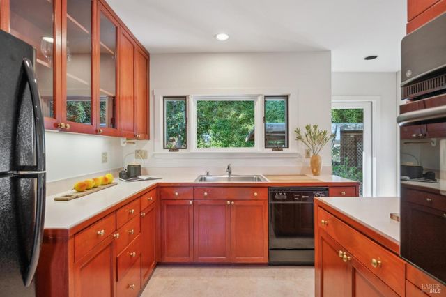 a kitchen with a sink stove and cabinets