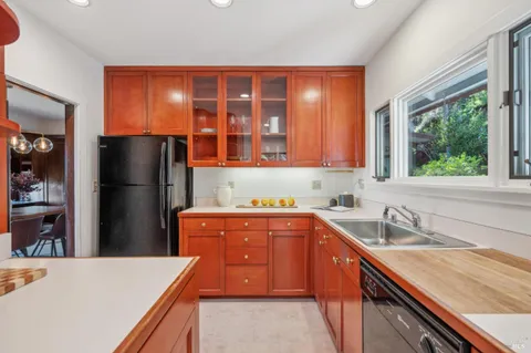 a kitchen with stainless steel appliances granite countertop a refrigerator and a sink