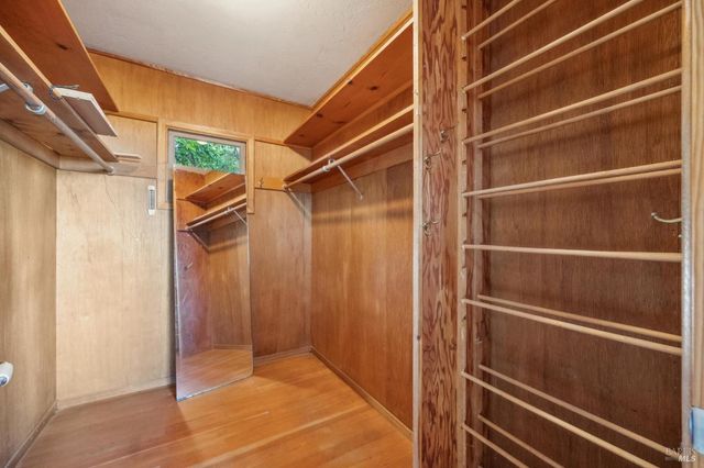a view of walk in closet with empty racks
