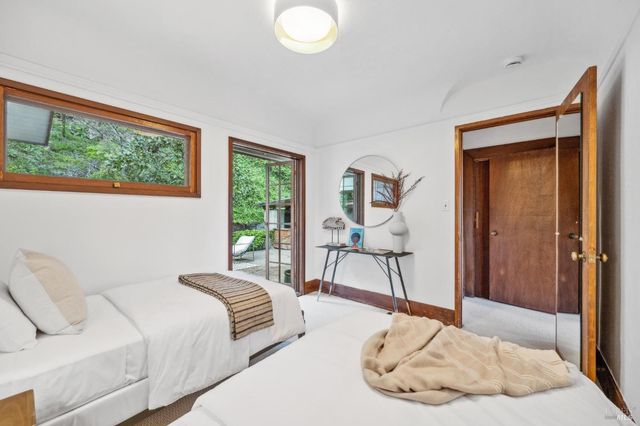 a bedroom with a bed and a large window