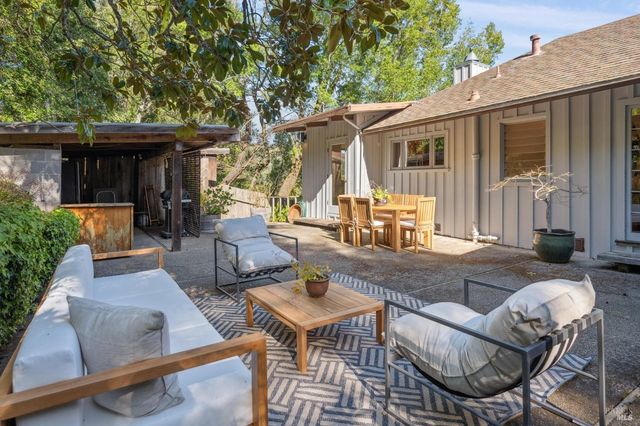 a view of a house with backyard and sitting area