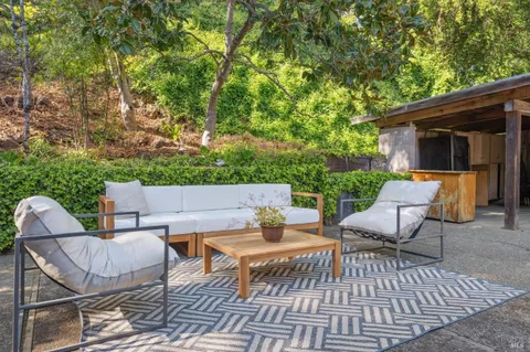 a view of a patio with couple of chairs