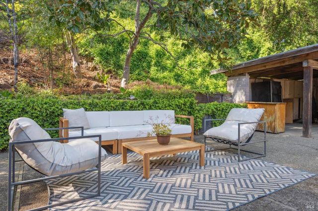 a view of a patio with couple of chairs