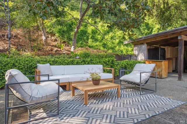 a view of a patio with couple of chairs