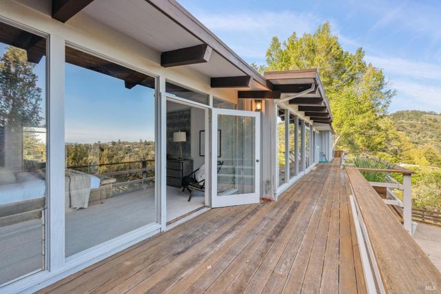 a view of a balcony with wooden floor