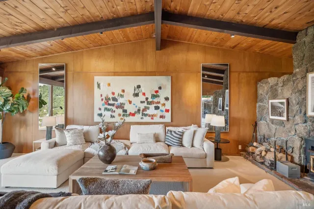 a living room with furniture and painting on the wall