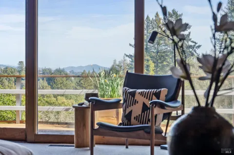 a view of a porch with furniture and a yard