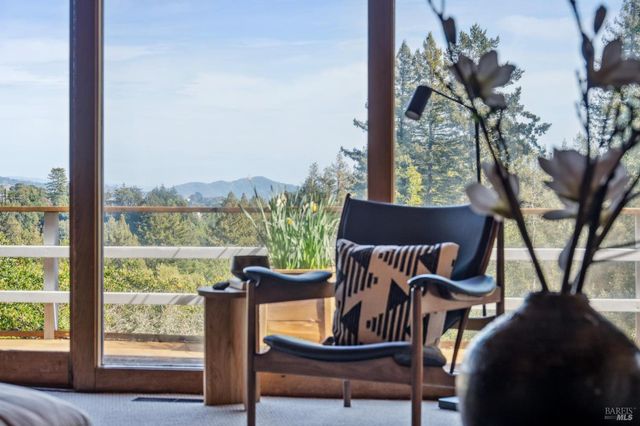 a view of a porch with furniture and a yard