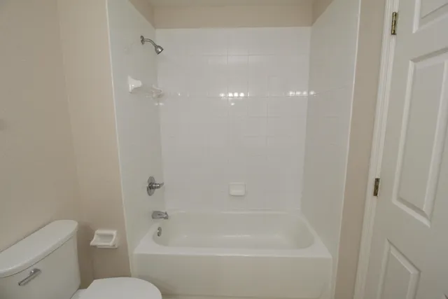 a bathroom with a bathtub and a toilet