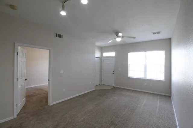 an empty room with windows and closet