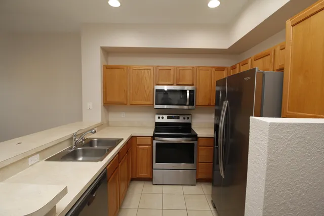 a kitchen with a refrigerator sink and stove