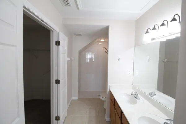 a bathroom with a tub sink and mirror