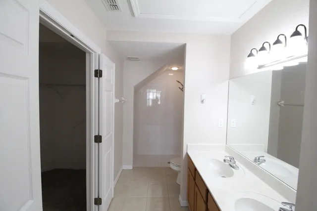 a bathroom with a tub sink and mirror