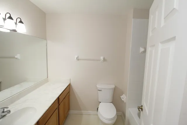 a white toilet sitting next to a bathroom sink