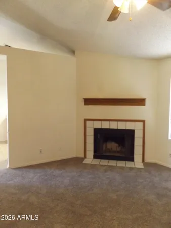 a view of an empty room with a fireplace