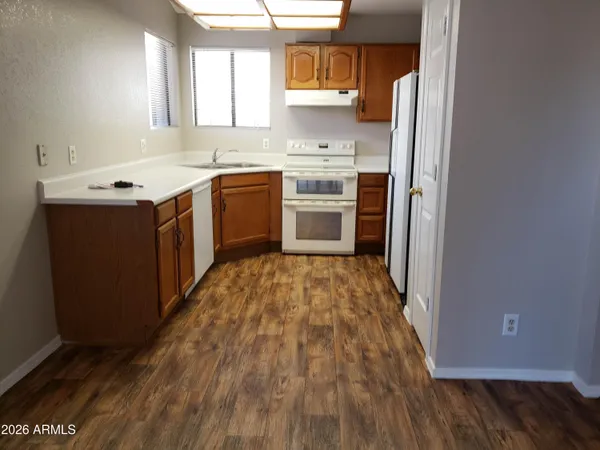 a kitchen with a sink stove and cabinets